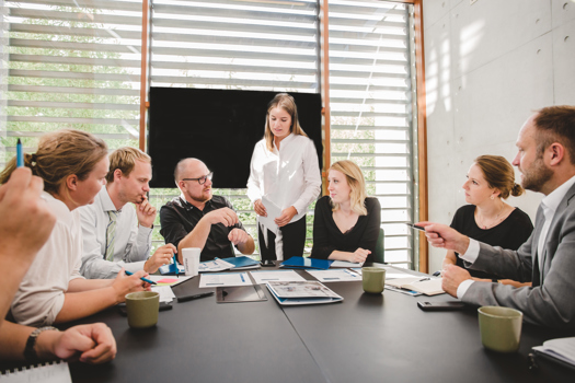 People in a meeting room with test material from Master International